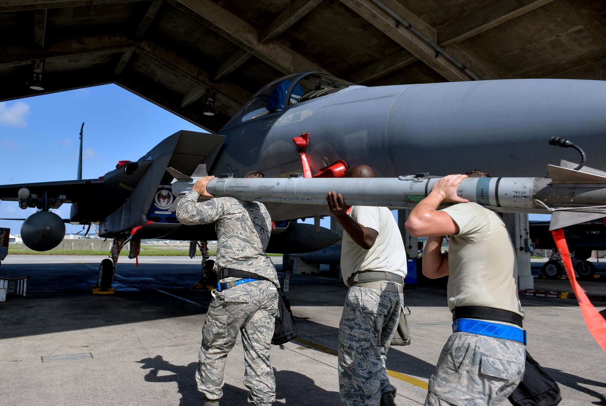 Weapons load crew team members from the 44th Aircraft Maintenance Unit carry an AIM-9L/M Sidewinder missile during a quarterly weapons load competition Oct. 24, 2016, at Kadena Air Base, Japan. In order for load crews to compete, they must prove themselves during monthly proficiency loads, quarterly evaluations and daily mission performance. (U.S. Air Force photo by Naoto Anazawa/Released)
