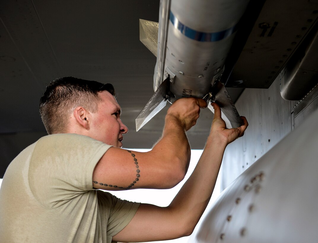 U.S. Air Force Senior Airman Brady Clark, 18th Aircraft Maintenance Squadron weapons load crew member, tightens a screw on an AIM-9L/M Sidewinder missile during a quarterly weapons load competition Oct. 24, 2016, at Kadena Air Base, Japan. The teams competed to have the fastest times while completing a munitions load with no safety write-ups. (U.S. Air Force photo by Naoto Anazawa/Released)
