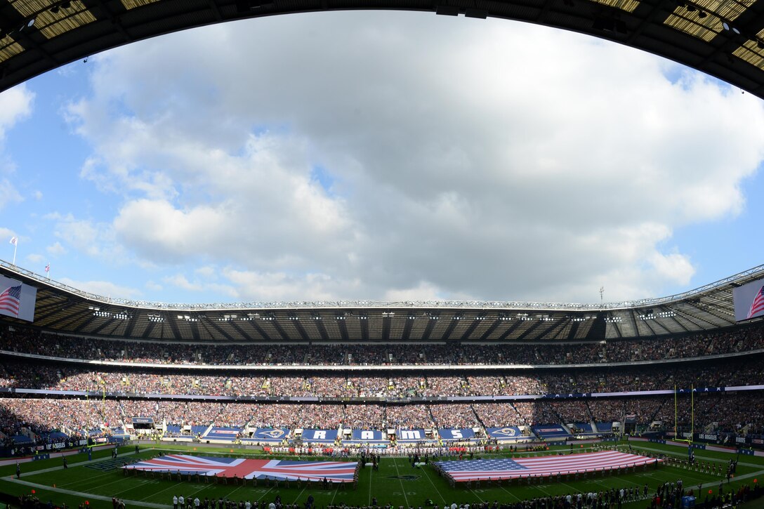 48th Fighter Wing Airmen and members of the Ministry of Defence hold the flags of the United States and United Kingdom, respectively, before kickoff of the second NFL International Series football game at Twickenham Stadium in London, England, Oct. 23. After presenting the flag, the Airmen watched the game played between the Los Angeles Rams and New York Giants, with the Giants winning 17-10. (U.S. Air Force photo/Airman 1st Class Eli Chevalier)