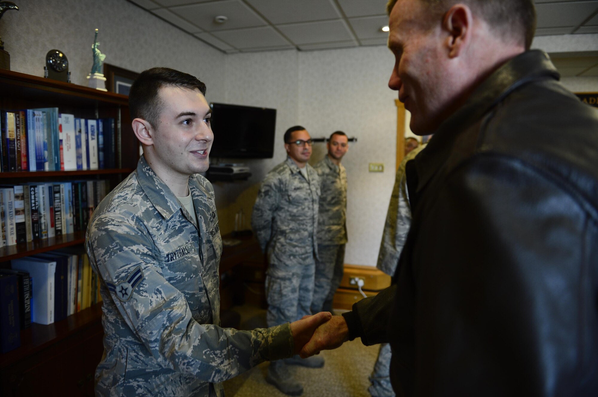 Gen. Tod Wolters, U.S. Air Forces in Europe and Air Forces Africa commander, coins 48th Fighter Wing Airmen during his visit to Royal Air Force Lakenheath, England, Oct. 25. Three Airmen were coined for their various contributions to mission accomplishment. (U.S. Air Force photo by Senior Airman Malcolm Mayfield)