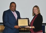 DLA EEO director, Ferdinand LeCompte presents Katrina Labouliere with a certificate of appreciation.