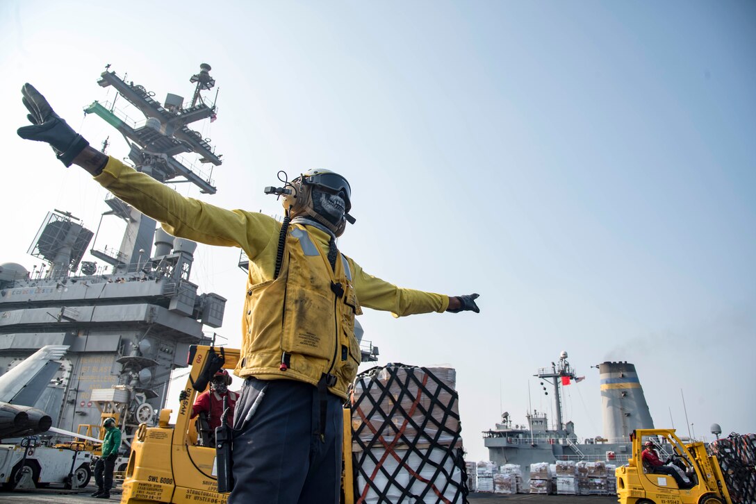161014-N-TV337-029

ARABIAN GULF (Oct. 14, 2016) Petty Officer 2nd Class Leighton Raglon directs an MH-60S Sea Hawk helicopter assigned to the Dusty Dogs of Helicopter Sea Combat Squadron (HSC) 7 as it unloads cargo on the flight deck of the aircraft carrier USS Dwight D. Eisenhower (CVN 69) (Ike) during a replenishment-at-sea with the fleet replenishment oiler USNS Pecos (T-AO 197). Raglon works as an aviation boatswain's mate (handling) aboard Ike and is responsible for the safe directing and moving of aircraft on the ship. Ike and its Carrier Strike Group are deployed in support of Operation Inherent Resolve, maritime security operations and theater security cooperation efforts in the U.S. 5th Fleet area of operations. (U.S. Navy photo by Seaman Casey S. Trietsch)