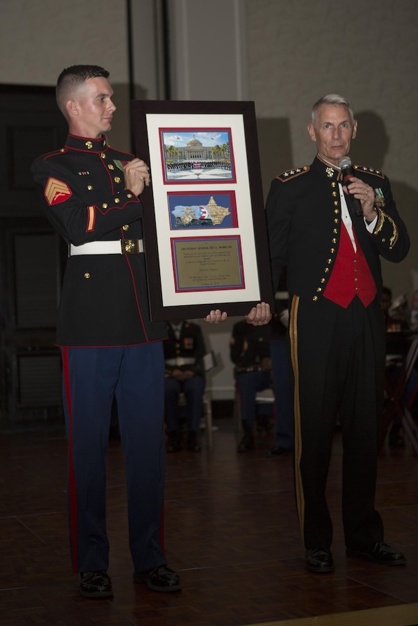 Lt. Gen. Rex C. McMillian, commander of Marine Forces Reserve and Marine Forces North, accepts a gift from Detachment 1, Landing Support Company, Combat Logistics Regiment 45, 4th Marine Logistics Group, for being the guest of honor during their 241st Marine Corps Birthday Ball celebration in Rio Grande, Puerto Rico, Oct. 22, 2016. The Reserve Marines are celebrating the 241st birthday as well as the Marine Corps Reserve Centennial anniversary. For the past week they have joined Marine Corps Band New Orleans to commemorate 100 years of rich history, heritage, espirit-de-corps, and a bond with not only Puerto Rico but with communities across the U.S. (U.S. Marine photo by Sgt. Sara Graham/Released)