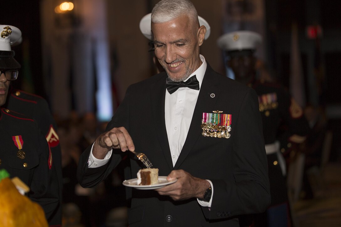 Retired Sgt. Maj. Jose Santiago takes a bite of cake as part of the tradition of being the oldest Marine present at the Detachment 1, Landing Support Company, Combat Logistics Regiment 45, 4th Marine Logistics Group, 241st Marine Corps Birthday Ball celebration here, Oct. 22, 2016. The Reserve Marines are celebrating the 241st birthday as well as the Marine Corps Reserve Centennial anniversary. For the past week they have joined Marine Corps Band New Orleans to commemorate 100 years of rich history, heritage, espirit-de-corps, and a bond with not only Puerto Rico but with communities across the U.S. (U.S. Marine photo by Sgt. Sara Graham/Released)