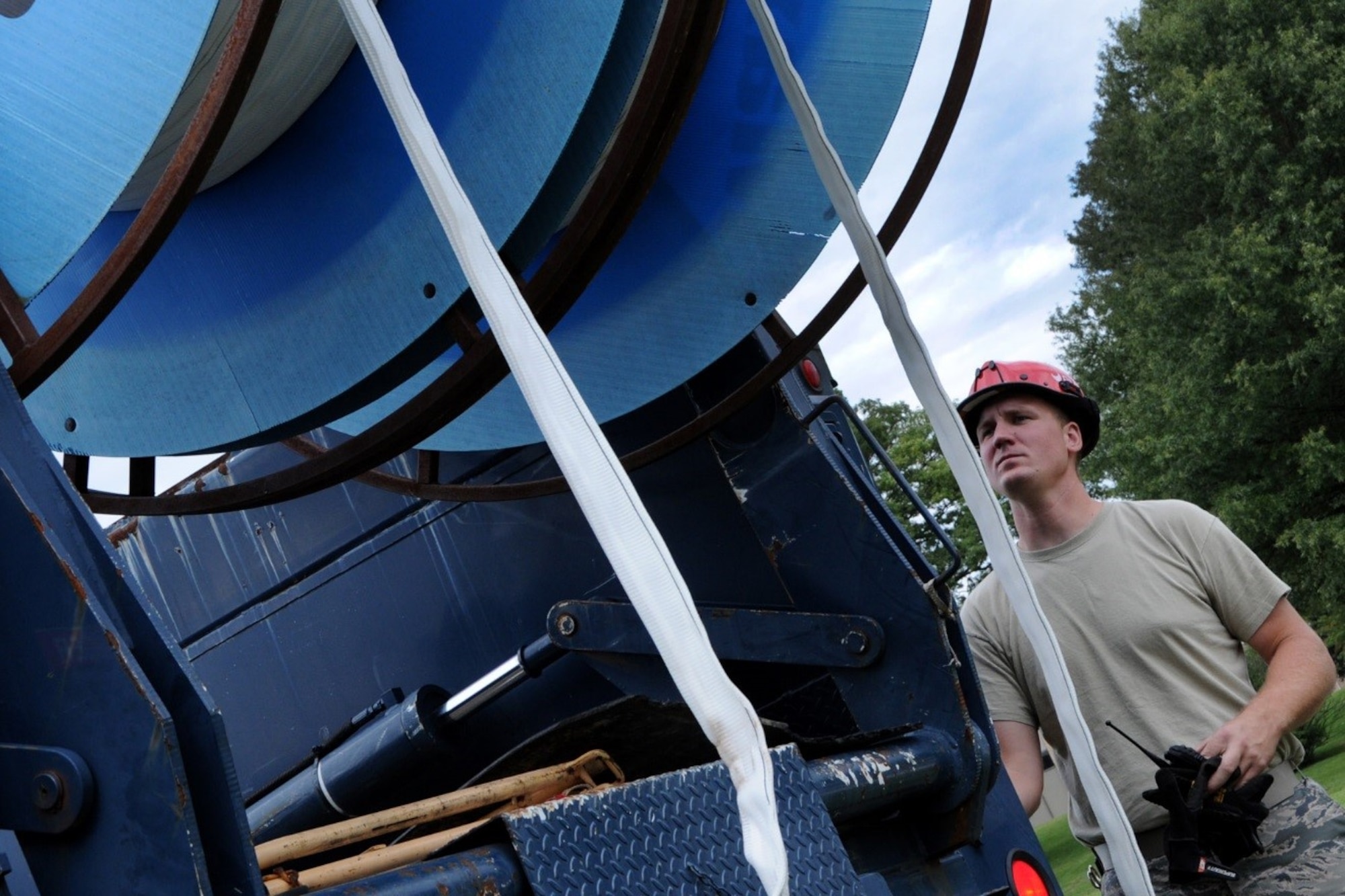 Airman First Class Michael Eckhoff, 744th Communications Squadron cable antenna maintenance apprentice, lowers inner duct fabric for running 1,600 feet of fiber optic cable to the flight line on Joint Base Andrews Oct. 13, 2016. The 744th CS delivers many cyberspace operations such as secure networks, voice communications services, and communications infrastructure and intrusion detection systems within the National Capital Region.  (U.S Air Force photo/Tech. Sgt. Matt Davis)