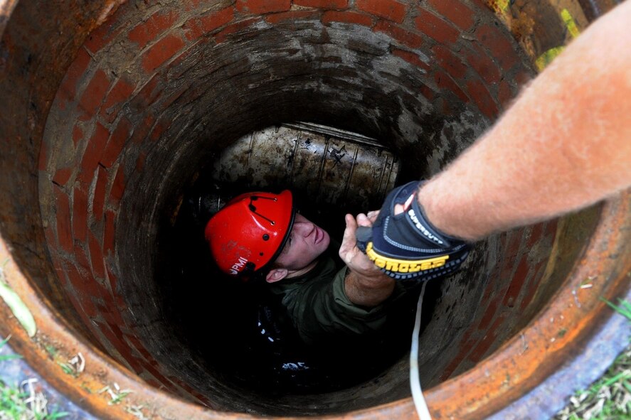 Senior Airman Cameron Porter and Airman First Class Michael Eckhoff, 744th Communications Squadron cable antenna maintenance, lower inner duct fabric for running 1,600 feet of fiber optic cable to the flight line on Joint Base Andrews Oct. 13, 2016. The 744th CS delivers many cyberspace operations such as secure networks, voice communications services, and communications infrastructure and intrusion detection systems within the National Capital Region.  (U.S Air Force photo/Tech. Sgt. Matt Davis)