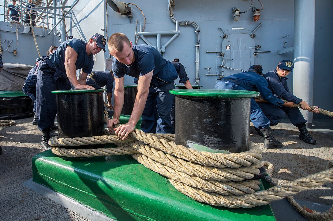 Sailors heave mooring lines aboard the amphibious assault ship USS Wasp Oct. 24, 2016 in Souda Bay, Oct. 24, 2016. The Wasp is supporting maritime security operations and theater security cooperation efforts in the U.S. 6th Fleet area of operations. Navy photo by Petty Officer 3rd Class Michael Molina