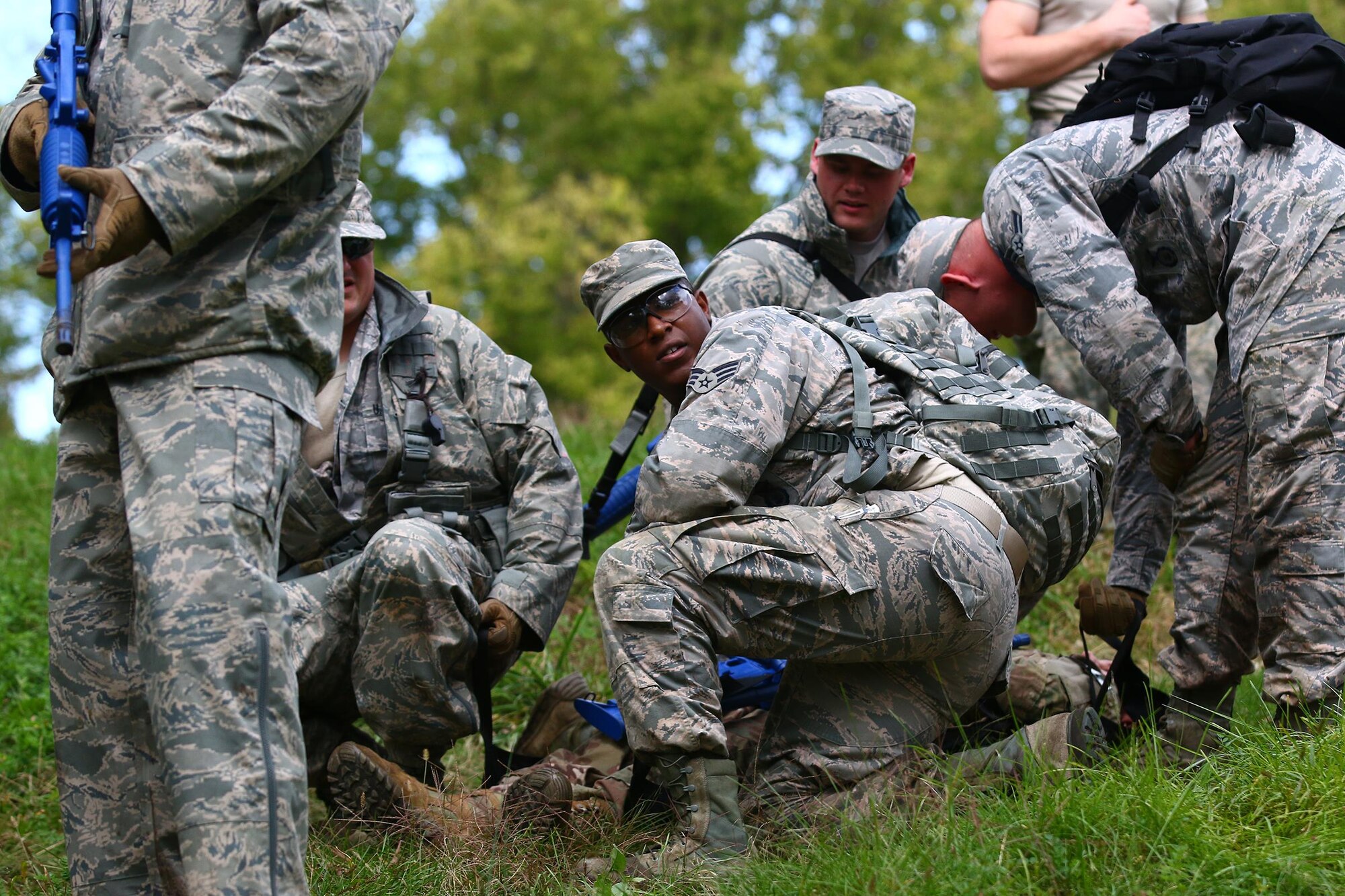Senior Airman Daryn Weatherspoon (facing) and other Airmen from the 445th Security Forces Squadron provide care for a simulated injured Airmen under fire during a land navigation training exercise here Oct. 2, 2016. Security forces members must accurately and effectively perform their tactical capabilities to defend against threats. The exercise provided an opportunity for traditional and full-time reservists to train together. (U.S. Air Force photo /Tech. Sgt. Patrick O’Reilly)