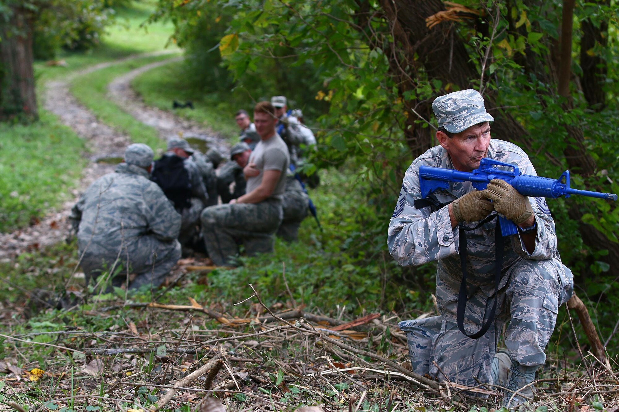 Master Sgt. Jonathon LeMaster, 445th Security Forces Squadron first sergeant, provides security at the rear while other members of SFS aids casualties after a simulated improvised explosive detonation during a land navigation training exercise held during the Oct. 2, 2016 unit training assembly.Security forces members must accurately and effectively perform their tactical capabilities to defend against threats. (U.S. Air Force photo /Tech. Sgt. Patrick O’Reilly)