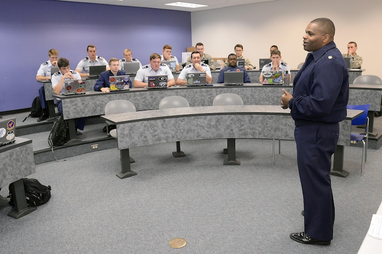 Maj. Paul Prosper, an assistant professor in the U.S. Air Force Academy’s Management Department, teaches class Oct. 24, 2016. Prosper keeps a busy schedule balancing his duties as an educator with improving the lives of children and at-risk young adults in Colorado Springs. (U.S. Air Force photo/Mike Kaplan)   