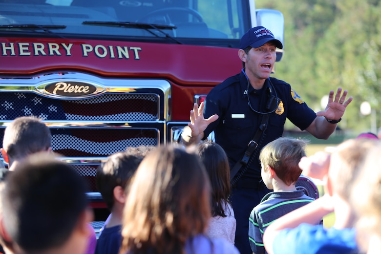 Edward Hudson explains the functions of a ladder truck to students at W.J. Gurganus Elementary School in Havelock, N.C., Oct. 20, 2016. The Cherry Point Fire and Emergency Services Department visited the school to demonstrate what to do in fire emergencies and how to prevent them. The students also learned about the equipment firefighters use every day to complete their mission. Hudson is a fire captain with the Cherry Point Fire and Emergency Services Department. (U.S. Marine Corps photo by Lance Cpl. Mackenzie Gibson/Released)