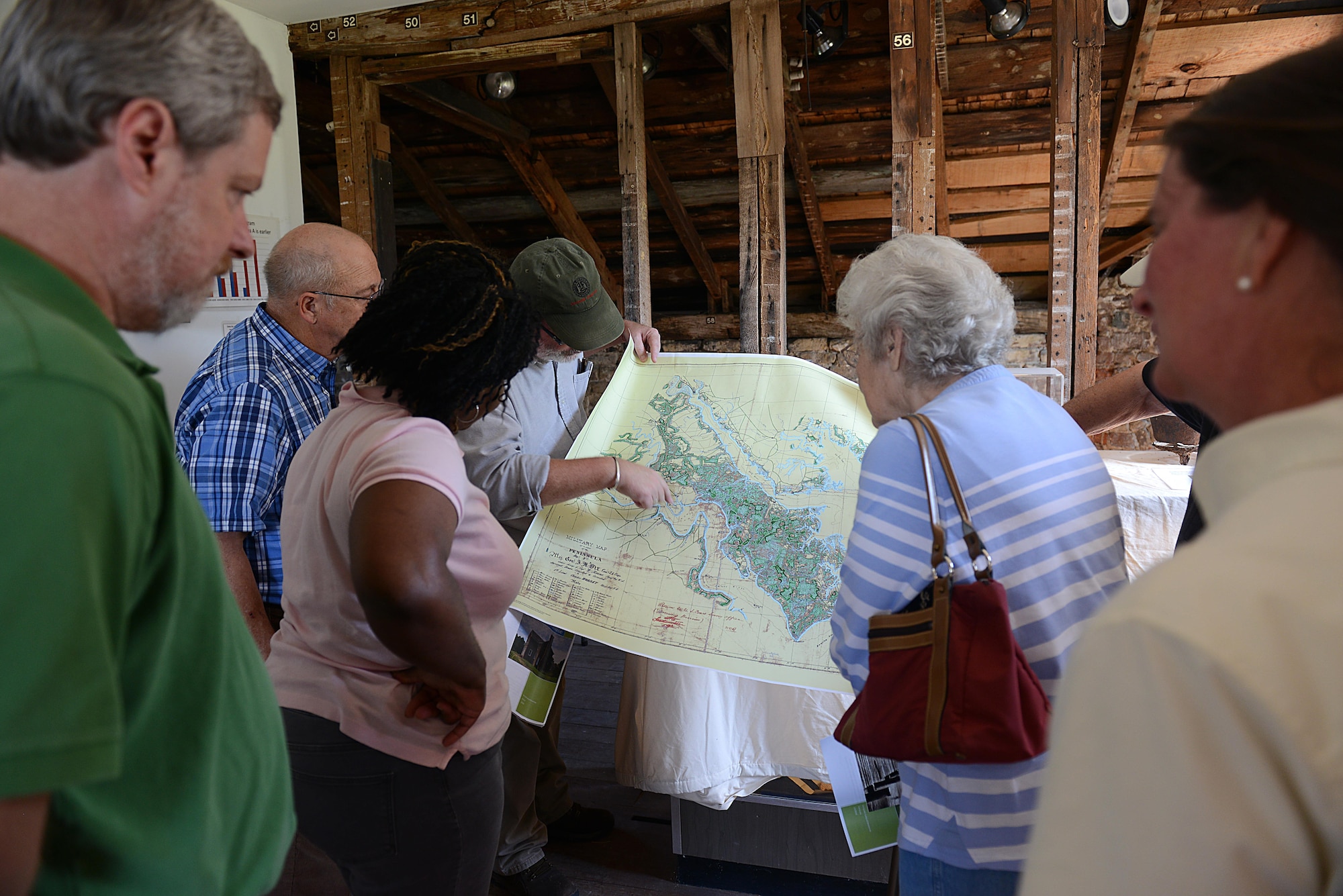 Christopher McDaid, 733rd Civil Engineer Squadron Environmental Element archeologist, shows guests a map of Mulberry Island during the Archaeology open house at Joint Base Langley-Eustis, Va., Oct. 19, 2016. The oldest building on the installation is available for group tours upon request throughout the year. (U.S. Air Force photo by Staff Sgt. Teresa J. Cleveland)