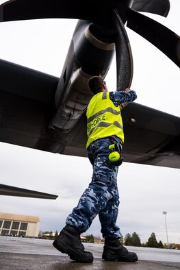 A Royal Australian Air Force C-130J crew member performs a preflight inspection of the aircraft's propellers at Mountain Home Air Force Base, Idaho, Oct. 23, 2016. The Australians visited the base to train with the 266th Range Squadron and take advantage of the Saylor Creek Training Range. (U.S. Air Force photo by Senior Airman Connor J. Marth/Released)