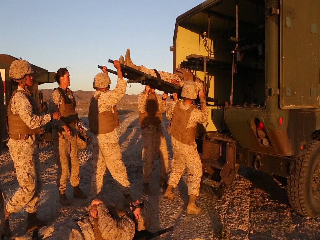 U.S. Navy medical technicians load a simulated casualty into a medical service HMMWV to bring him to an evacuation site during a  Marine Corps Combat Readiness Evaluation completed by 1st Medical Battalion, 1st Marine Logistics Group at Camp Pendleton, Calif., Oct 17-21, 2016. The MCCRE was designed to push the Sailors and Marines to the limit with scenarios they would be likely to see in a combat environment such as improvised explosive devices, downed aircraft and mass casualty drills. Marines and Sailors were required to work side-by-side to ensure mission success. (U.S. Marine Corps photo by Lance Cpl. Jocelyn Ontiveros)