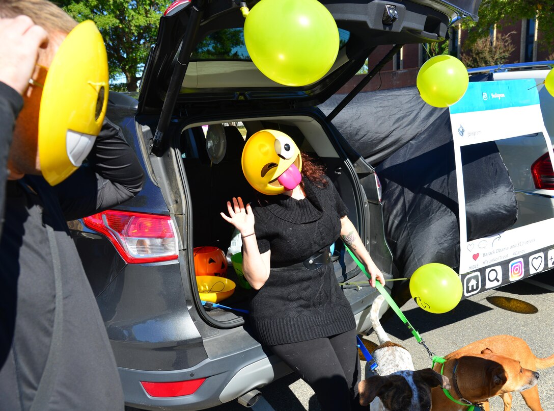 U.S. Air Force Staff Sgt. Teresa Cleveland, 633rd Air Base Wing Public Affairs photojournalist, mans the 633 ABW PA trunk during the Trunk-or-Treat event at Joint Base Langley-Eustis, Va., Oct. 22, 2016. The event is hosted annually by the Airmen & Family Readiness Center to support and alternative trick-or-treating event for JBLE members. (U.S. Air Force photo by Airman 1st Class Tristan Biese)