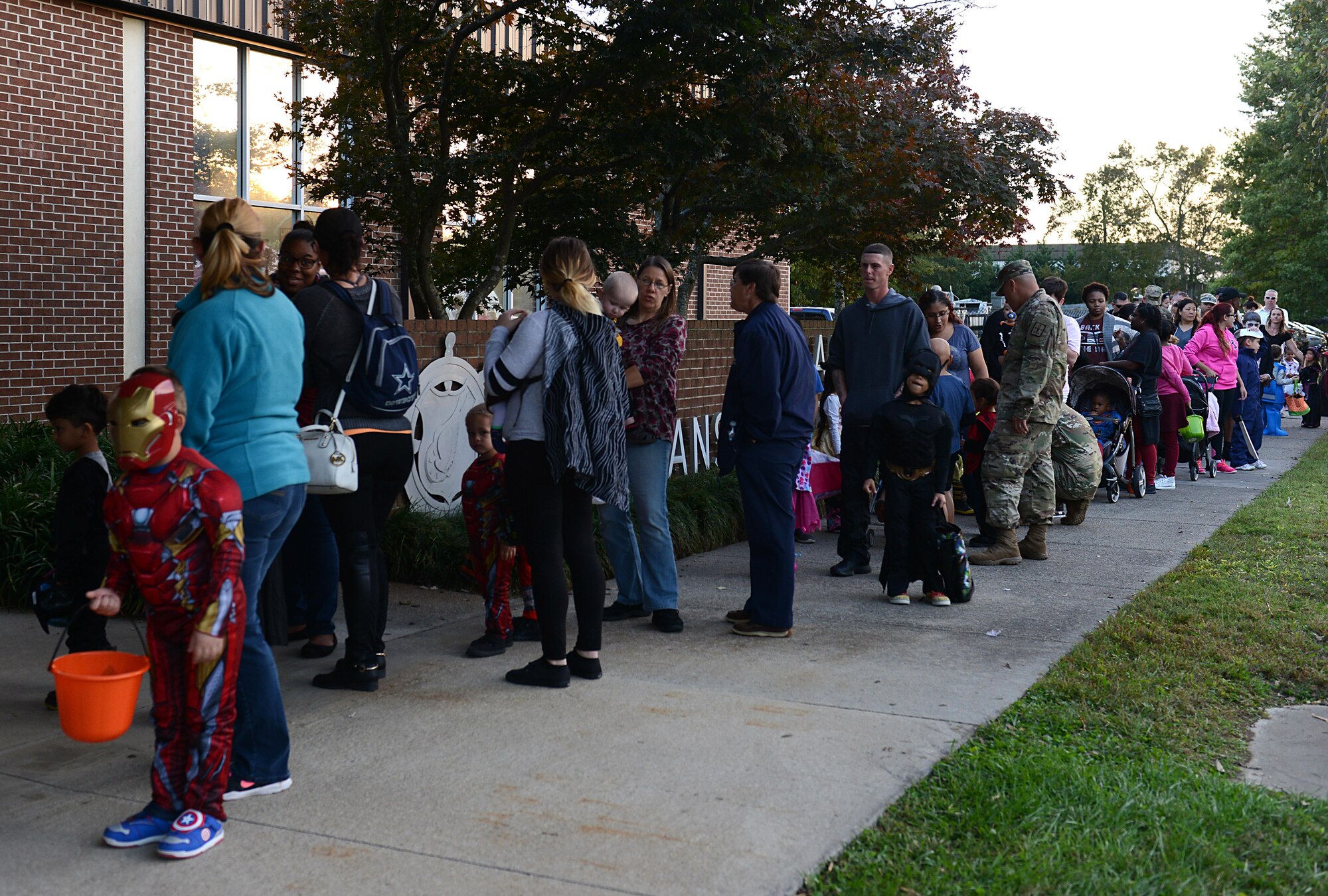 Families line up for Night at the Transportation Museum event at Joint Base Langley-Eustis, Va., Oct. 24, 2016. The event provided family-friendly and educational trick-or-treating, featuring historical reenactments by actors. (U.S. Air Force photo by Staff Sgt. Teresa J. Cleveland)