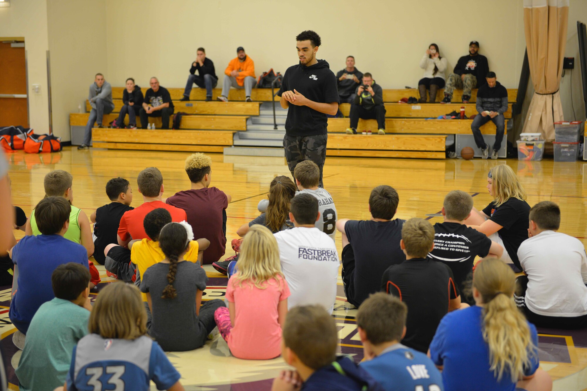 Tyus Jones, Minnesota Timberwolves point guard, talks with participants at the military kids basketball clinic Oct. 22.