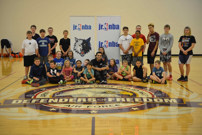 Tyus Jones, Minnesota Timberwolves point guard, poses with participants at the military kids basketball clinic Oct. 22.