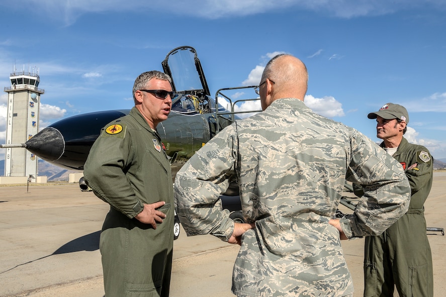 Lt. Col. Ron King, left, and Jim Harkins, both pilots from the 82nd Aerial Targets Squadron, Detachment 1, Holloman Air Force Base, New Mexico, talk with Col. Dana Pelletier, 75th Mission Support Group commander, during a QF-4 Aerial Target aircraft static display at Hill AFB, Oct. 25. (U.S. Air Force photo by Paul Holcomb) 