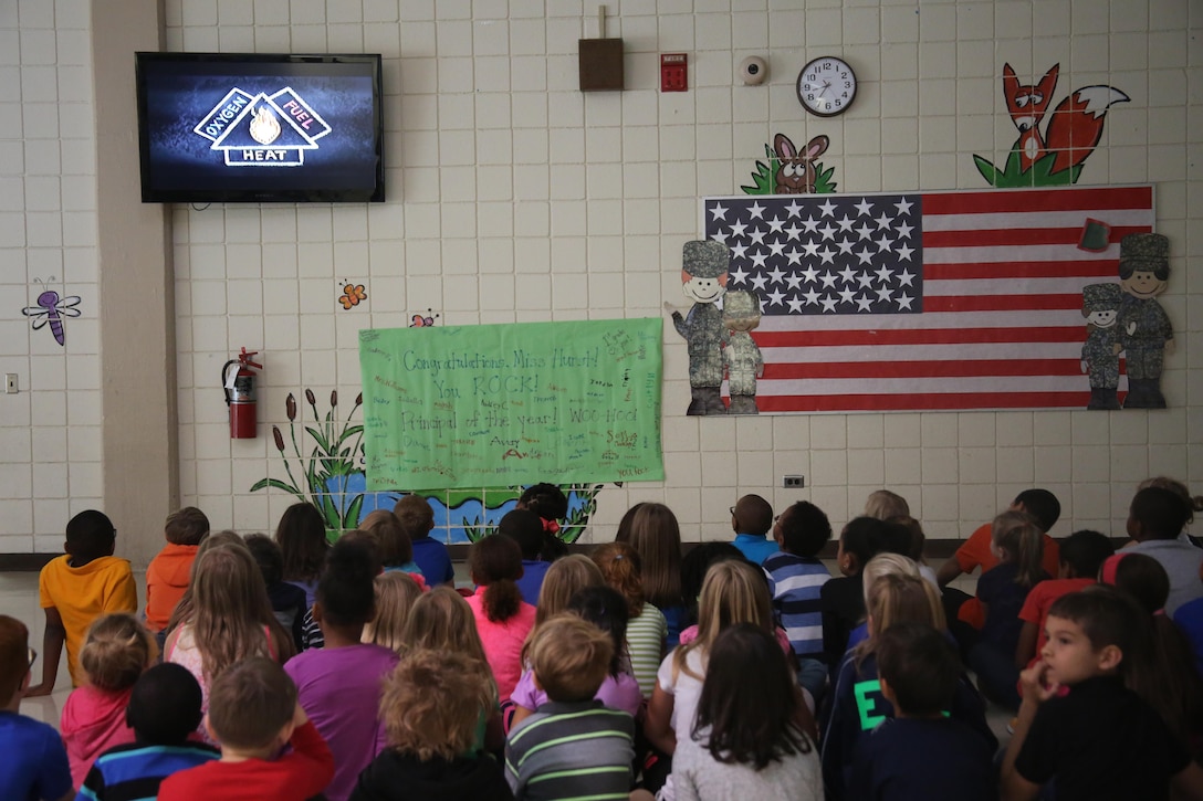 A group of second graders watch an educational fire safety video at W.J. Gurganus Elementary School in Havelock, N.C., Oct. 20, 2016. The Cherry Point Fire and Emergency Services Department visited the school to demonstrate what to do in fire emergencies and how to prevent them. The students also learned about the equipment firefighters use every day to complete their mission. (U.S. Marine Corps photo by Lance Cpl. Mackenzie Gibson/Released)