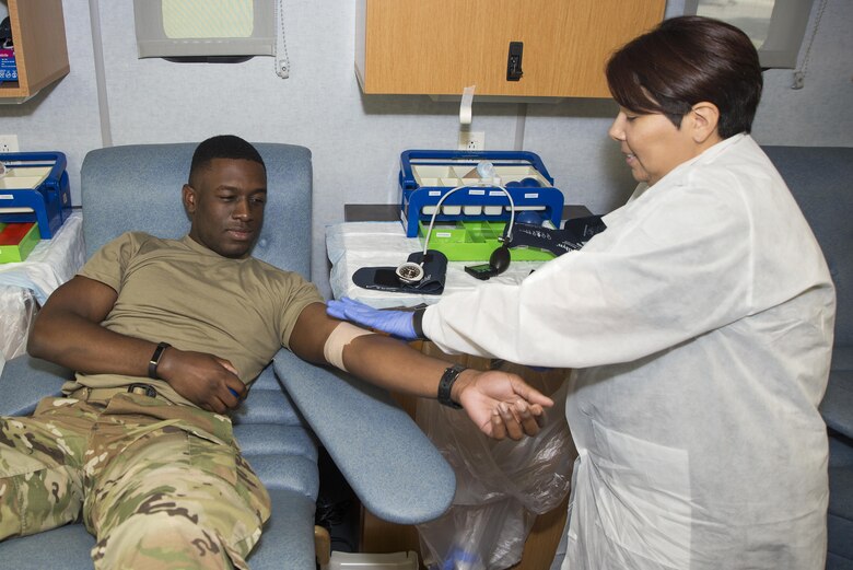 Jessica Carrillo (left), Joint Base San Antonio-Lackland Blood Donor Center phlebotomist, prepares to sanitize the arm of U.S. Army Spc. Jonathan Alexander, Brooke Army Medical Center medical laboratory technician, before he gives blood at JBSA-Randolph Oct. 5, 2016. The blood donor center supplies the Brooke Army Medical Center, the deployment in Afghanistan, the Veteran's Administration and military hospitals across the country. 