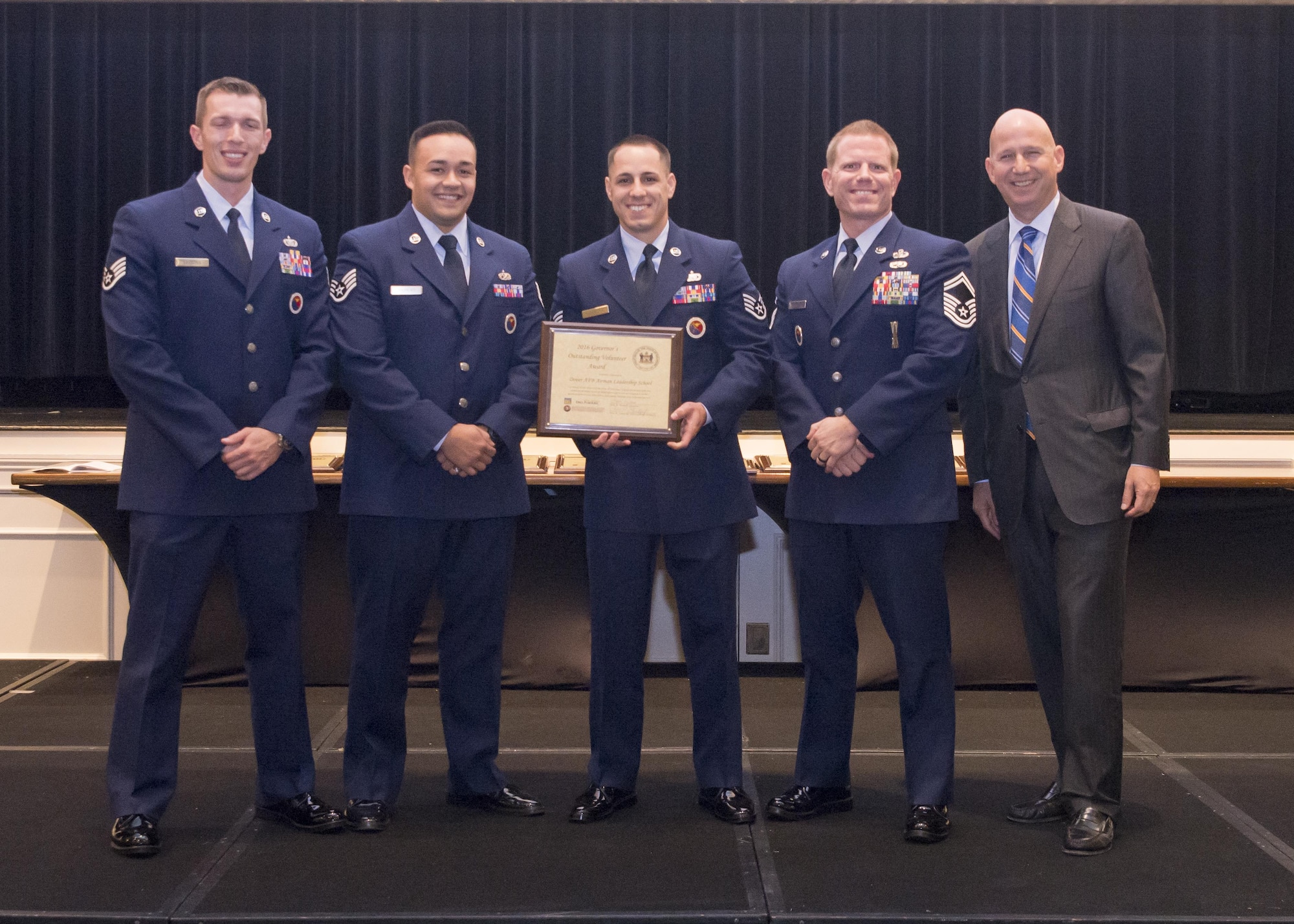 From left to right, Staff Sgts. Brian Lecates, Robert Andrews and Chad Hardesty, 436th Force Support Squadron Airman Leadership School cadre, Senior Master Sgt. Jason Barnshaw, 436th FSS ALS commandant, receive the 2016 Governor’s Outstanding Volunteer Service Award from Gov. Jack Markell during a reception and dinner at Dover Downs Hotel Oct. 9, 2016. In 2015, the cadre motivated and led more than 215 people, providing more than 1,000 volunteer hours in the local community. Their service saved an estimated $10,000 in contracting and other fees. (Courtesy photo)