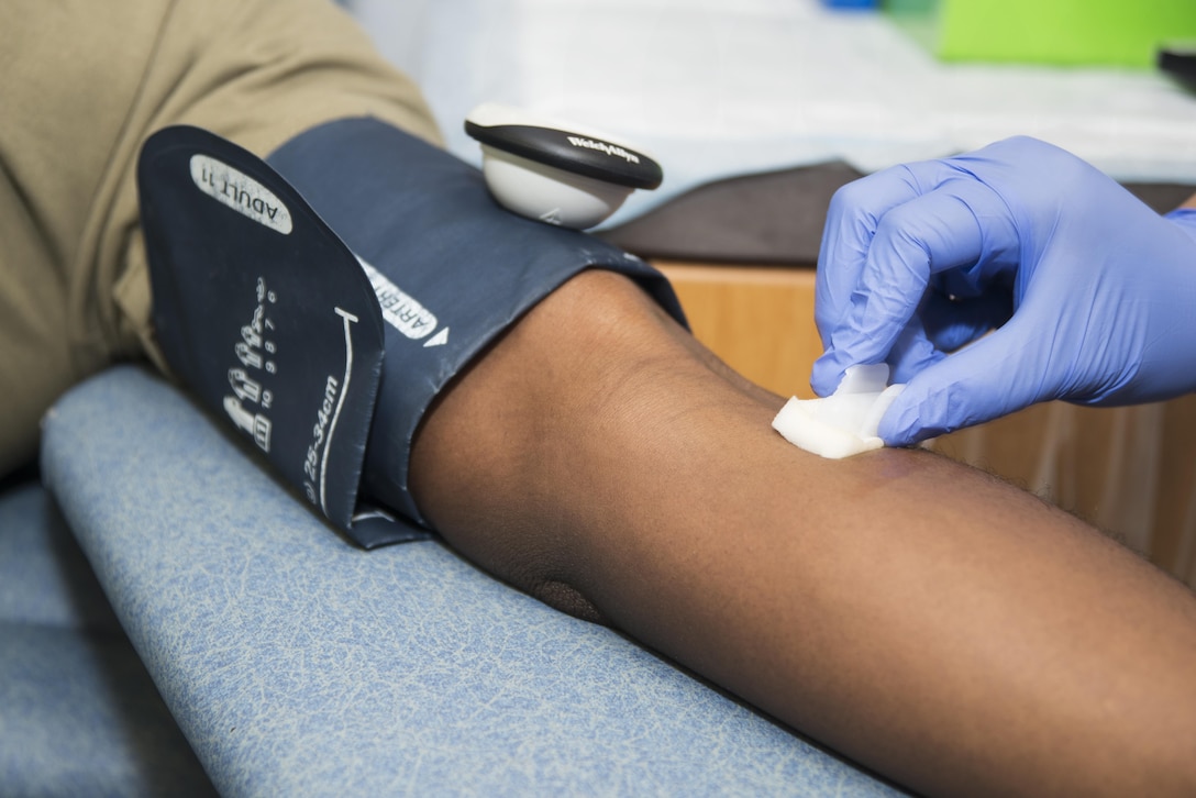 Jessica Carrillo, Joint Base San Antonio-Lackland Blood Donor Center phlebotomist, sanitizes the arm of U.S. Army Spc. Jonathan Alexander, Brooke Army Medical Center medical laboratory technician, before he gives blood at JBSA-Randolph Oct. 5, 2016. Donors can donate blood every eight weeks, plasma once a month or platelets once a week. 