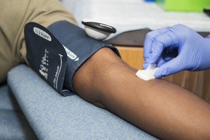 Jessica Carrillo, Joint Base San Antonio-Lackland Blood Donor Center phlebotomist, sanitizes the arm of U.S. Army Spc. Jonathan Alexander, Brooke Army Medical Center medical laboratory technician, before he gives blood at JBSA-Randolph Oct. 5, 2016. Donors can donate blood every eight weeks, plasma once a month or platelets once a week. 