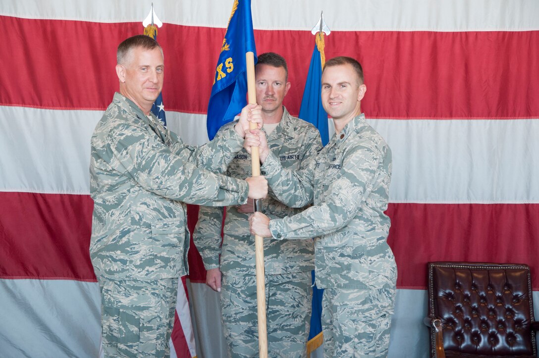 Col. Brett Newman, 419th Maintenance Group commander, passes the 419th Maintenance Squadron flag to Maj. Glendon Bute during a change of command ceremony at Hill Air Force Base, Utah, Oct. 21. (U.S. Air Force photo/Tech. Sgt. Michael McCool)