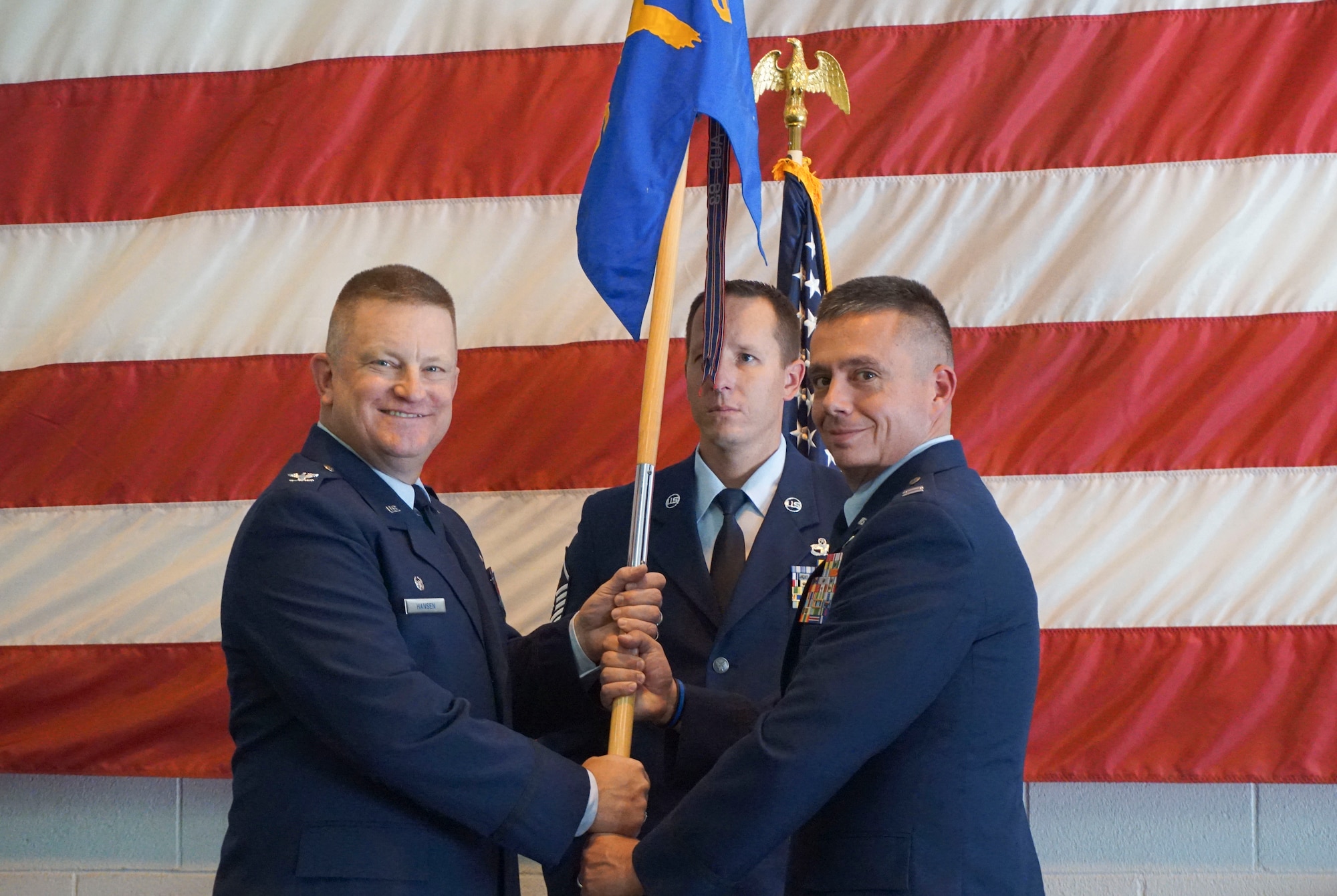 Col. Kent Hansen, 419th Mission Support Group commander, passes the 419th Security Forces Squadron flag to Capt. Juan Cabrera during an assumption of command ceremony at Hill Air Force Base, Utah, Oct. 22. (U.S. Air Force photo/Tech. Sgt. Christina Judd)