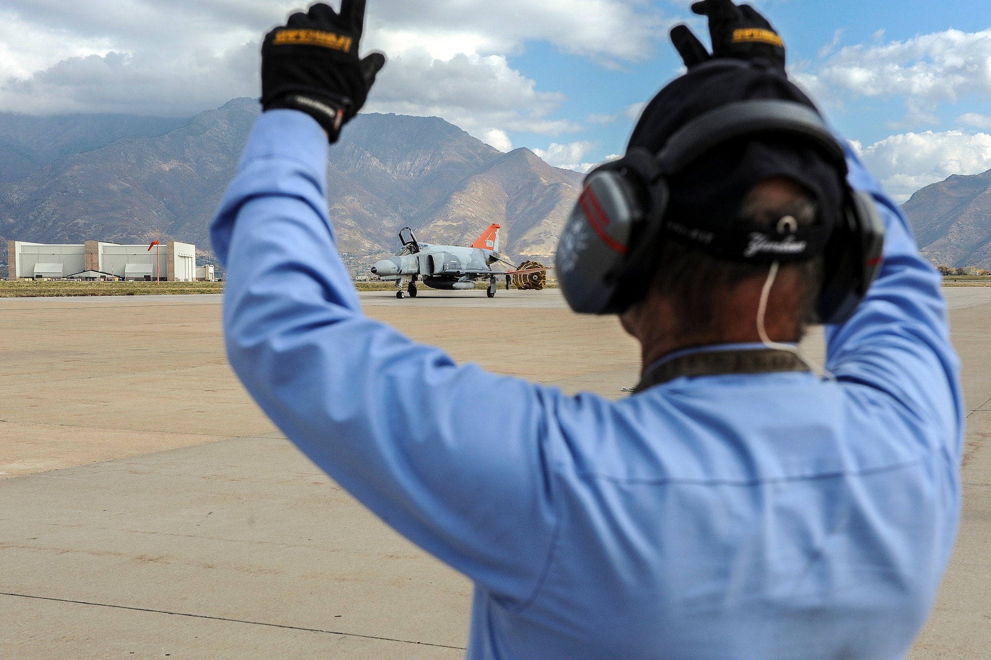 Terry Spalding, 75th Operations Support Squadron, marshals a QF-4 Aerial Target aircraft piloted by Lt. Col. Ron King, 82nd Aerial Targets Squadron, Detachment 1 commander, Holloman Air Force Base, New Mexico, at Hill Air Force Base, Oct. 25. (U.S. Air Force photo by Micah Garbarino)