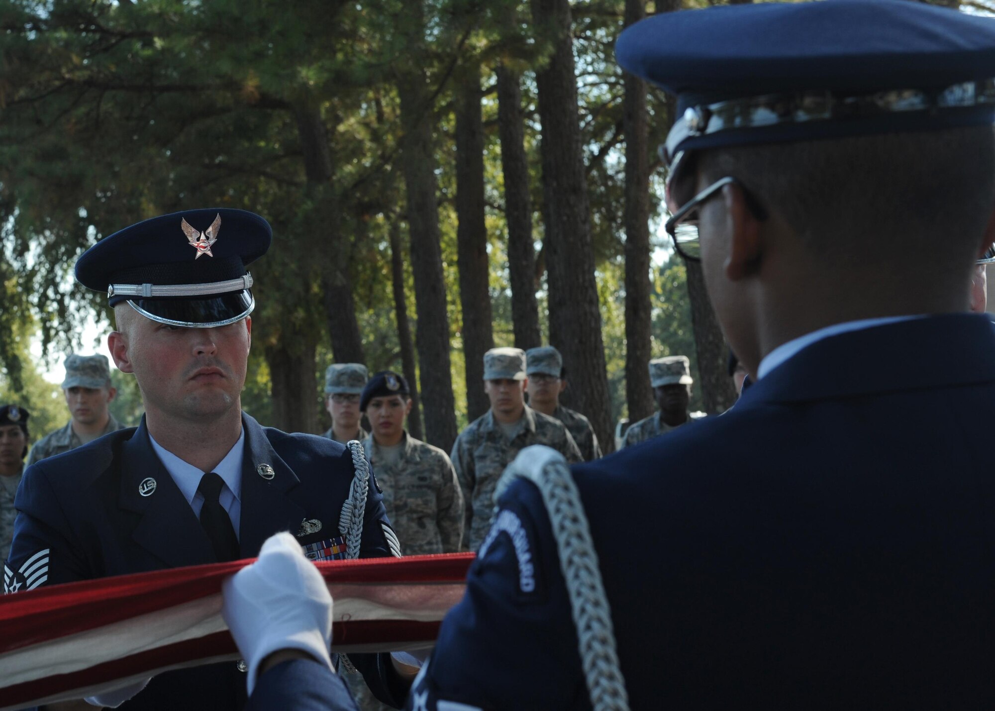 U.S. Air Force Staff Sgt. James Gentry, Team Little Rock Honor Guard Ceremonial Guardsman, assists with a seven-man flag fold Oct. 6, 2016, at Little Rock Air Force Base, Ark. Honor Guard members are trained in a variety of military ceremonial services. (U.S. Air Force photo by Airman Grace Nichols)