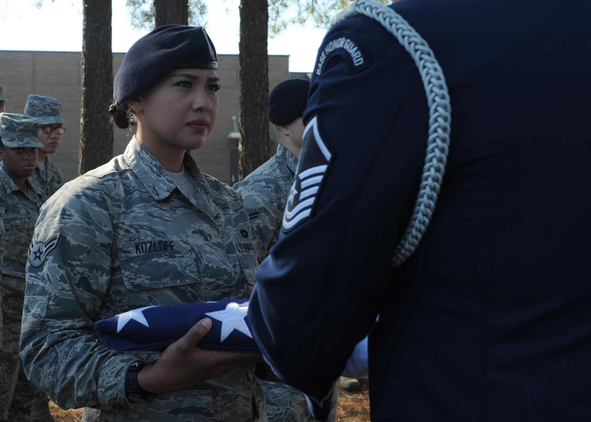 U.S. Air Force Airman 1st Class Sasha Kozloff, 19th Security Forces Squadron Defender, accepts a flag during an Honor Guard demonstration as part of the First Term Airman’s Class Oct. 6, 2016. Team Little Rock’s Honor Guard demonstrated proper funeral procedures at the bi-monthly FTAC class to recruit Airmen. (U.S. Air Force photo by Airman Grace Nichols)