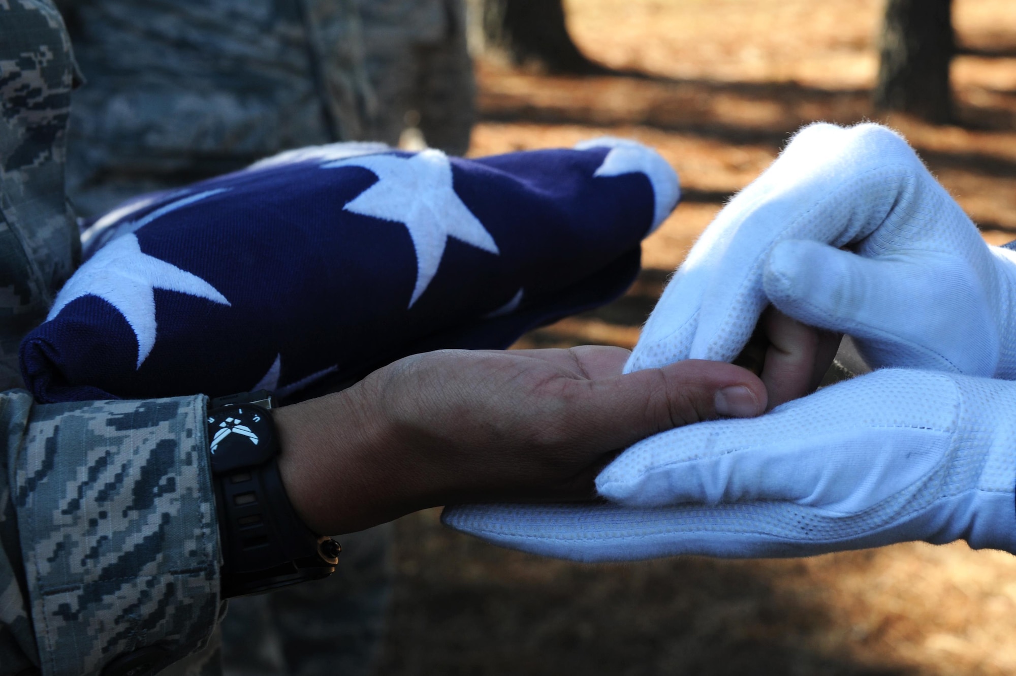 Symbolic firing rounds are placed in the hands of a service member Oct. 6, 2016, at Little Rock Air Force Base, Ark. The rounds symbolize the volleys fired in honor of service members. (U.S. Air Force photo by Airman Grace Nichols)