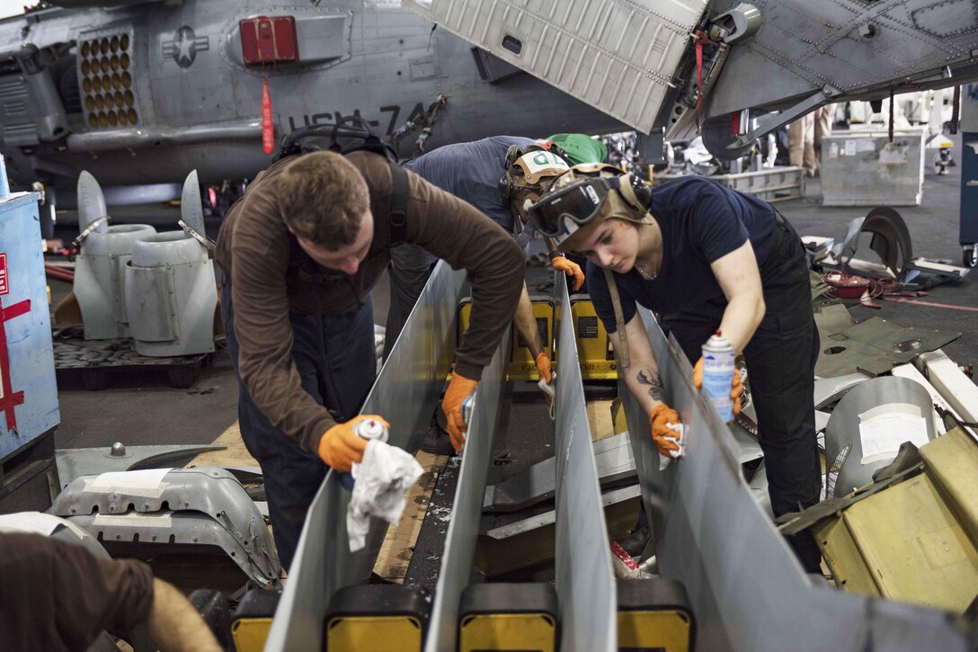 Sailors clean MH-60R Seahawk helicopter rotor blades in the hangar bay of the USS Dwight D. Eisenhower in the Persian Gulf, Oct. 25, 2016. The aircraft carrier is supporting Operation Inherent Resolve, maritime security operations and theater security cooperation efforts in the U.S. 5th Fleet area of operations. Navy photo by Seaman Joshua Murray
