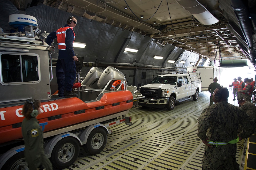 Members of the 349th Air Mobility Wing and 312th Airlift Squadron work with U.S. Coast Guard personnel to load and unload 25-foot (8 meter) Defender Class Response Boats Small (RB-S) aboard a C-5M Super Galaxy at Travis Air Force Base, Calif. (USAF Photo by Lt. Col. Robert Cousebaker)