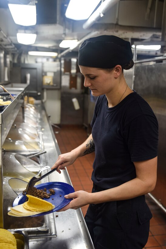 Navy Seaman Meggan Van Harn serves tacos in the galley of the forward mess decks of the aircraft carrier USS Dwight D. Eisenhower in the Persian Gulf, Oct. 25, 2016. Navy photo by Seaman Christopher A. Michaels