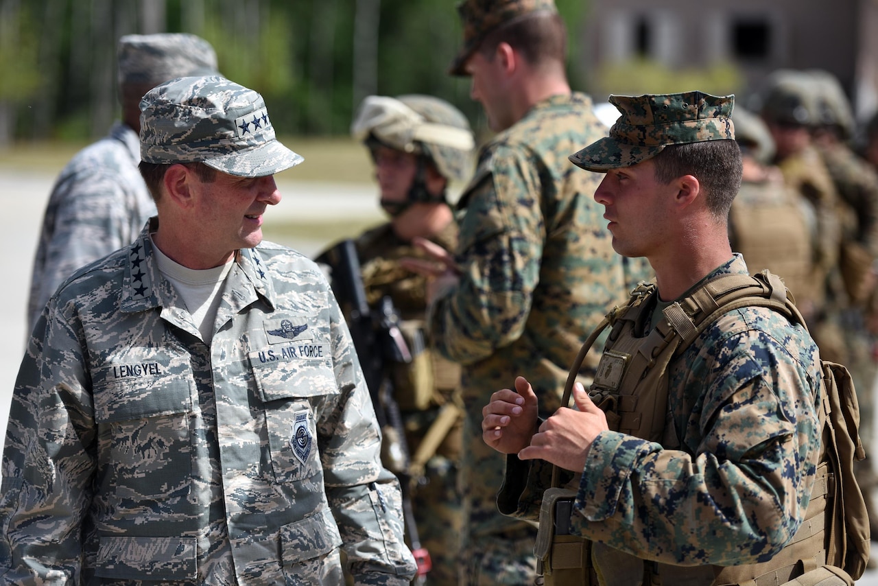 Air Force Gen. Joseph Lengyel, chief, National Guard Bureau, talks with Marines during a visit to Camp Grayling Joint Maneuver Training Center, Michigan, during exercise Northern Strike, Aug. 16, 2016. The general said that the Defense Department is working to streamline the process examining the bonuses or tuition assistance given to 13,000 California National Guardsmen. Army National Guard photo by Sgt. 1st Class Jim Greenhill