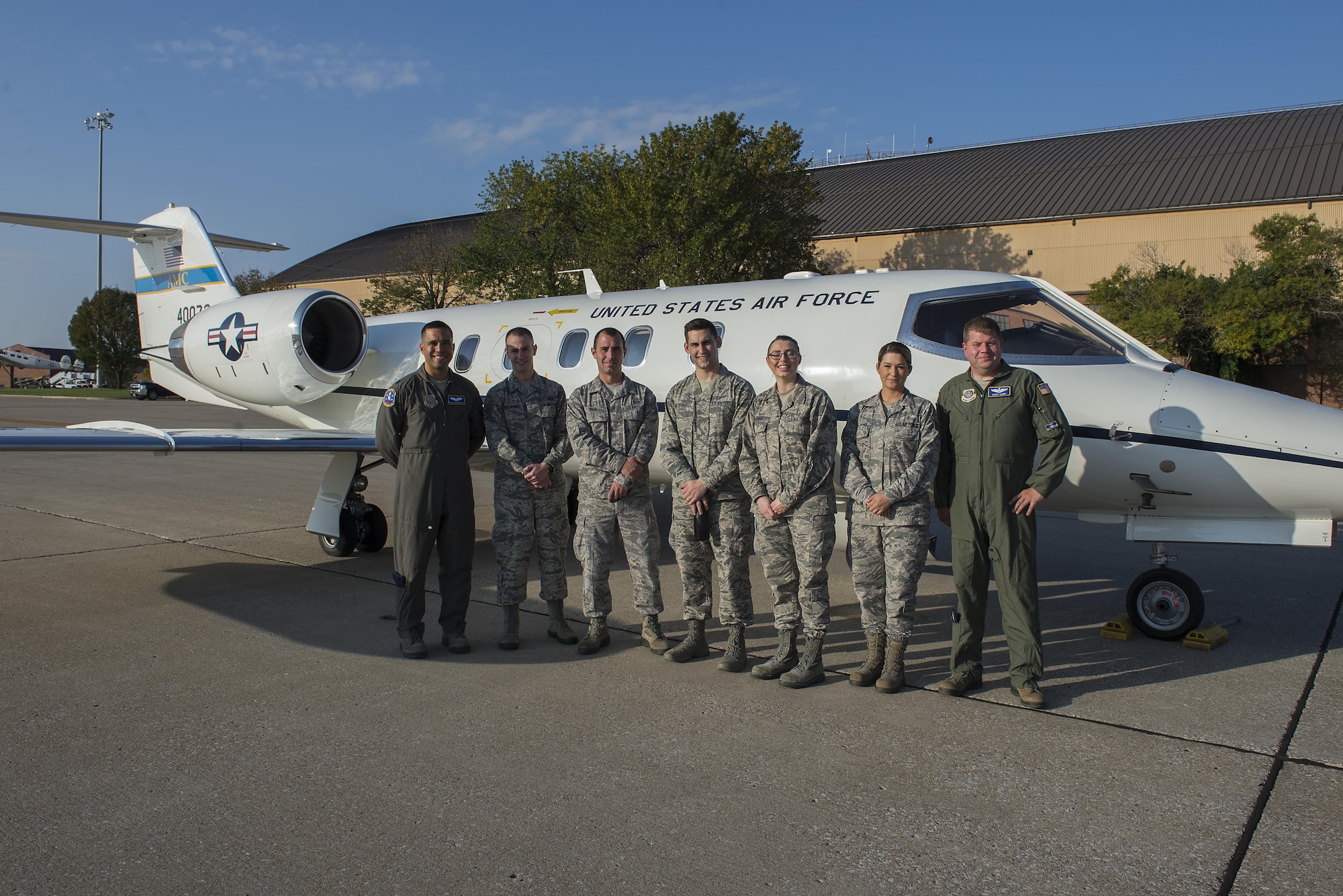 458th Airlift Squadron pilots and five Airmen pose in front of a C-21 prior to an incentive flight departing Scott Air Force Base, Ill., Oct. 18, 2016. The Airmen rewarded with this incentive flight were from around the base who showed hard work and dedication. (U.S. Air Force Photo by Senior Airman Megan Friedl)