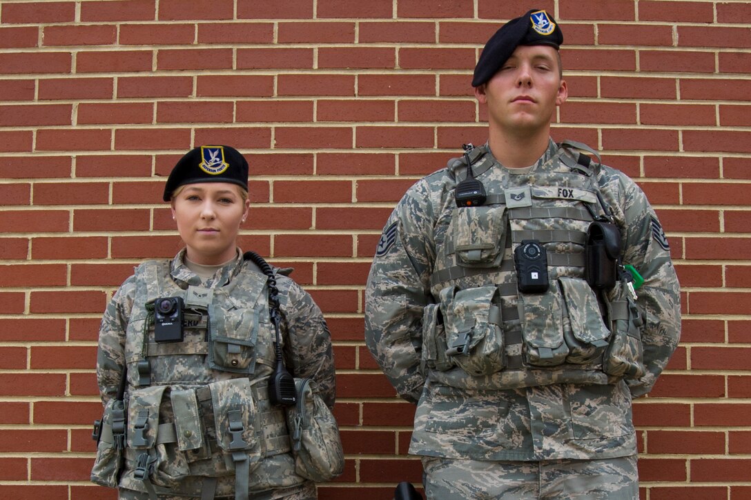 Airman 1st Class Sarah Shepherd, left, and Staff Sgt. Sawyer Fox, right, 11th Security Forces Squadron response force leaders, display the wear of body cameras at Joint Base Andrews, Md., Oct. 4, 2016. JBA defenders began donning the body worn cameras Oct. 26 as part of a six-month-long Air Force-level test to determine which product to use. The cameras will be evaluated on their video quality, usefulness, and how they can be better utilized. (U.S. Air Force photo by Senior Airman Jordyn Fetter)
