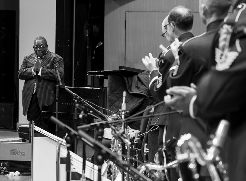 Members of the U.S. Air Force Band's Airmen of Note applaud Cyrus Chestnut, jazz pianist, during a 2016 Jazz Heritage Series performance at the Rachel M. Schlesinger Concert Hall in Alexandria, Va., Oct. 21, 2016. Chestnut, who has worked with many big bands, including the Lincoln Center Jazz Orchestra and the Dizzy Gillespie All-Star Big Band, was the featured guest during this series performance. The Airmen of Note established the Jazz Heritage Series in 1990 and each year they perform with legendary icons of jazz. (U.S. Air Force photo by Airman Gabrielle Spalding)