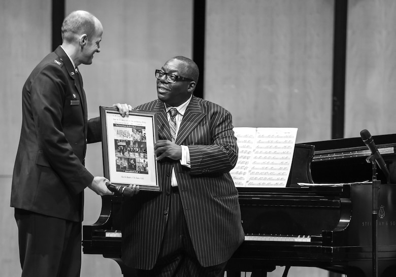 Col. E. John Teichert, Joint Base Andrews and 11th Wing commander, presents Cyrus Chestnut, jazz pianist, a token of appreciation during a 2016 Jazz Heritage Series performance at the Rachel M. Schlesinger Concert Hall in Alexandria, Va., Oct. 21, 2016. Each year, a Jazz Heritage Series performance features a legendary icon of jazz. Chestnut has worked with many big bands, including the Lincoln Center Jazz Orchestra and the Dizzy Gillespie All-Star Big Band. (U.S. Air Force photo by Airman Gabrielle Spalding)