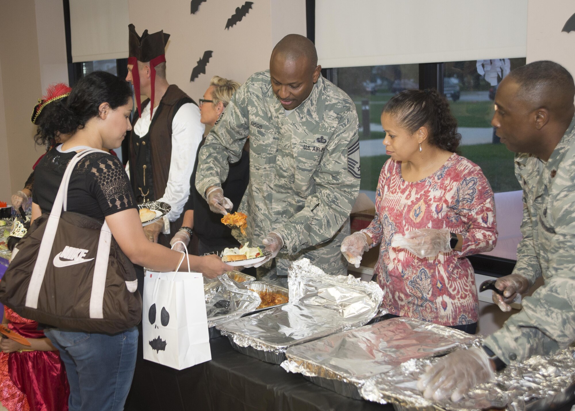 CMSgt Darryl Ross, 436th Force Support Squadron chief enlisted manager, serves food during the Deployed Families Dinner Oct. 20, 2016, at the Youth Center on Dover Air Force Base, Del. Food, drinks and entertainment were provided to give families and spouses of deployed Airmen a relaxing night, free from household duties. (U.S. Air Force photo by Staff Sgt. Jared Duhon)  