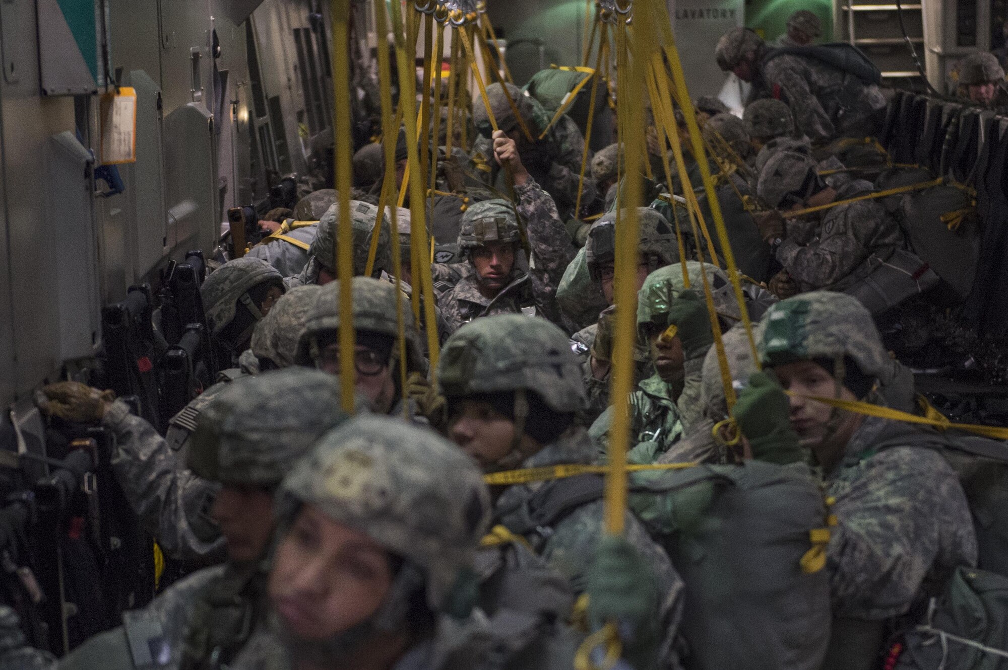 U.S. Army Alaska Soldiers assigned to the 4th Infantry Brigade Combat Team (Airborne), 25th Infantry Division, prepare to jump out of a C-17 Globemaster III during a formation flight from Joint Base Elmendorf-Richardson, Oct. 19, 2016.
