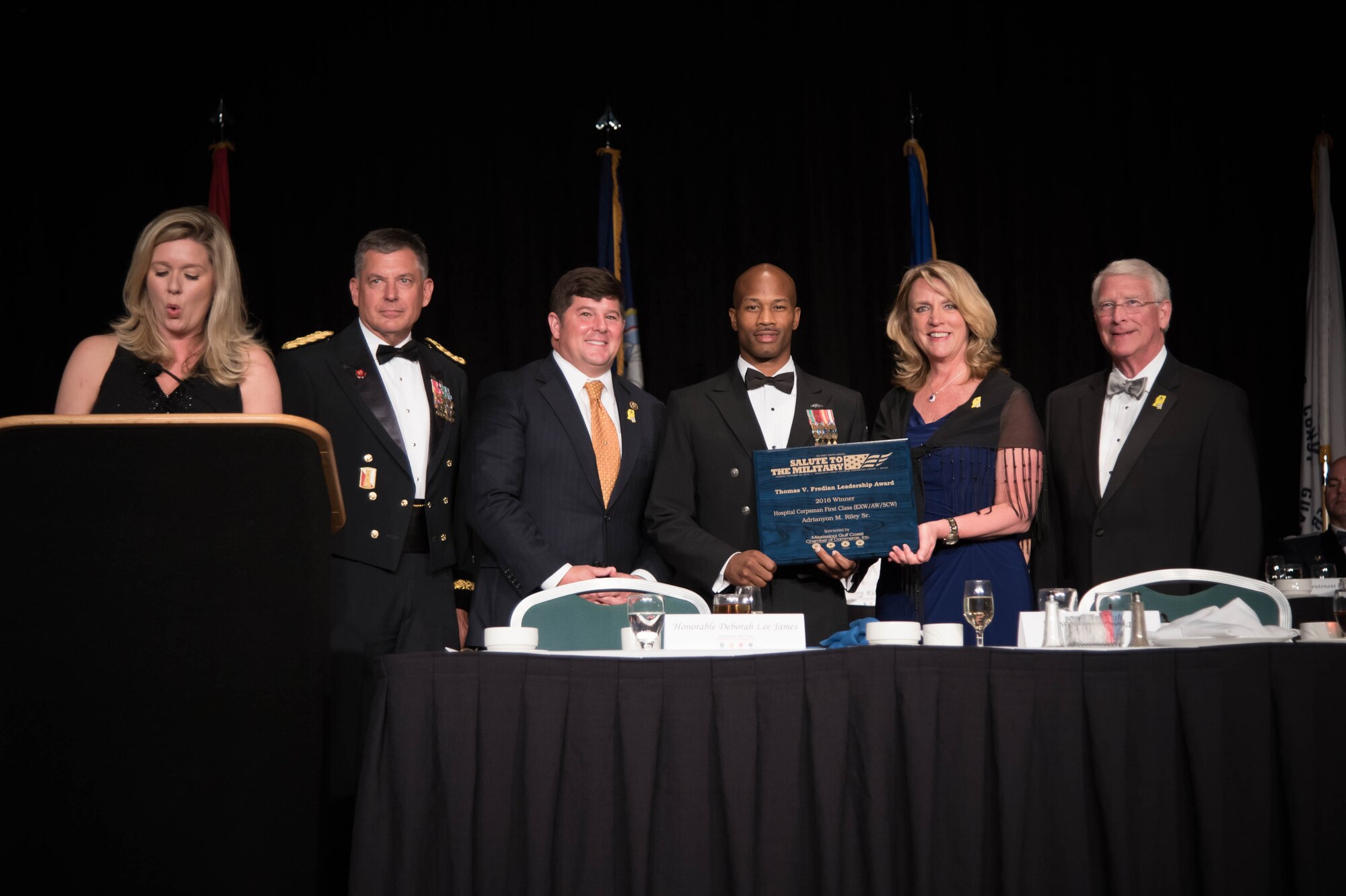 Secretary of the Air Force Deborah Lee James presents the Thomas V. Fredian Community Leadership Award to Navy Petty Officer 1st Class Adrianyon Riley  during the 38th Annual Salute to the Military event at the Gulf Coast Convention Center in Biloxi Miss. Oct. 25. (U.S. Air Force photo/Senior Airman Heather Heiney)