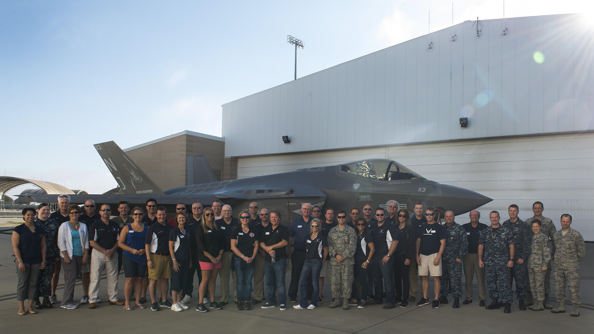 Dover Air Force Base honorary commanders, civic leaders and leadership, along with Eglin AFB and U.S. Navy Fighter Squadron 101 Grim Reapers leadership pose for a photo in front of an F-35C Lightning II during a community relations tour Oct. 20, 2016, at Eglin AFB, Fla. At Eglin, the group was also given a tour of the Joint Pre-integration of Munitions and Electronic Systems facility, the explosive ordinance disposal facility and a mobile emergency operations control vehicle. (U.S. Air Force photo by Senior Airman Zachary Cacicia)