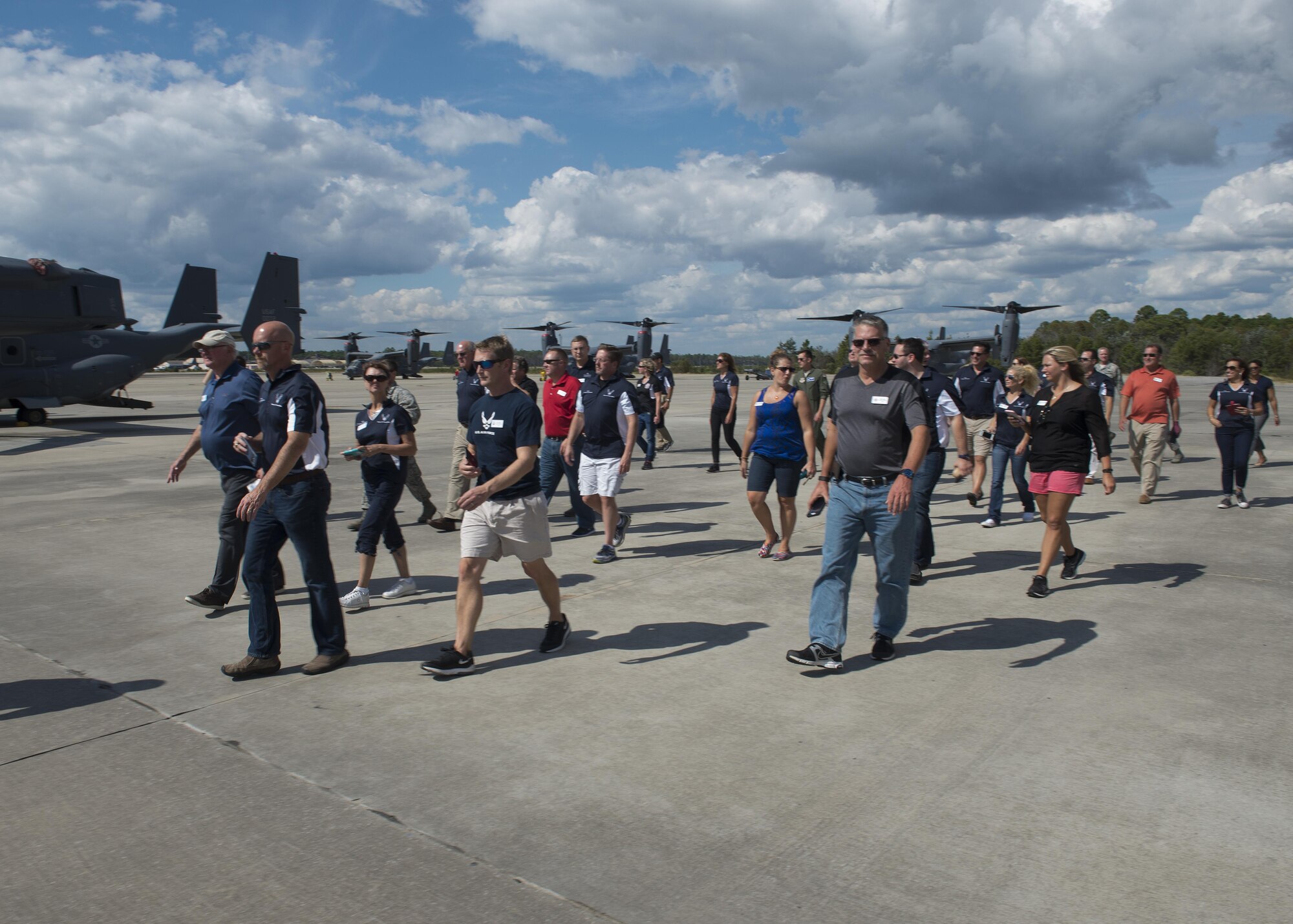 Team Dover honorary commanders and civic leaders walk past a squadron of CV-22 Ospreys during a community relations tour Oct. 20, 2016, at Hurlburt Field, Fla. The purpose of the CRT was to expand the knowledge of Team Dover honorary commanders to other mission sets that take place in the Air Force, but may not necessarily take place in the Air Mobility Command. (U.S. Air Force photo by Senior Airman Zachary Cacicia)
