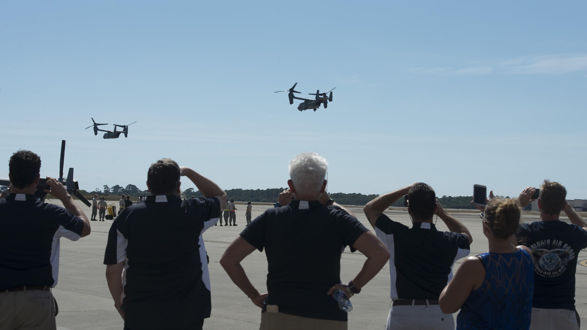 Team Dover honorary commanders and civic leaders watch two CV-22 Ospreys take off during a community relations tour Oct. 20, 2016, at Hurlburt Field, Fla. CV-22’s are multi-mission tiltrotor aircraft with vertical takeoff and landing capabilities. (U.S. Air Force photo by Senior Airman Zachary Cacicia)