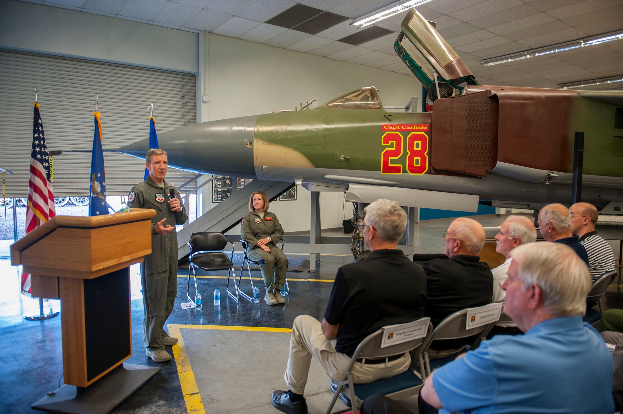 Gen. “Hawk” Carlisle, commander of Air Combat Command gives a speech during a dedication ceremony at the Threat Training Facility on Nellis Air Force Base, Nev., Oct. 17. During the ceremony, a MiG-23 was dedicated to honor his role in the CONSTANT PEG program. The mission of CONSTANT PEG was to train U.S. Air Force, U.S. Navy and U.S. Marine Corps combat fighter aircrews on the best ways to fight and win when encountering MiG built aircraft in aerial combat. Carlisle was the chief of weapons and tactics as well as flight commander for the 4477th Test and Evaluation Squadron from 1986 to 1988.