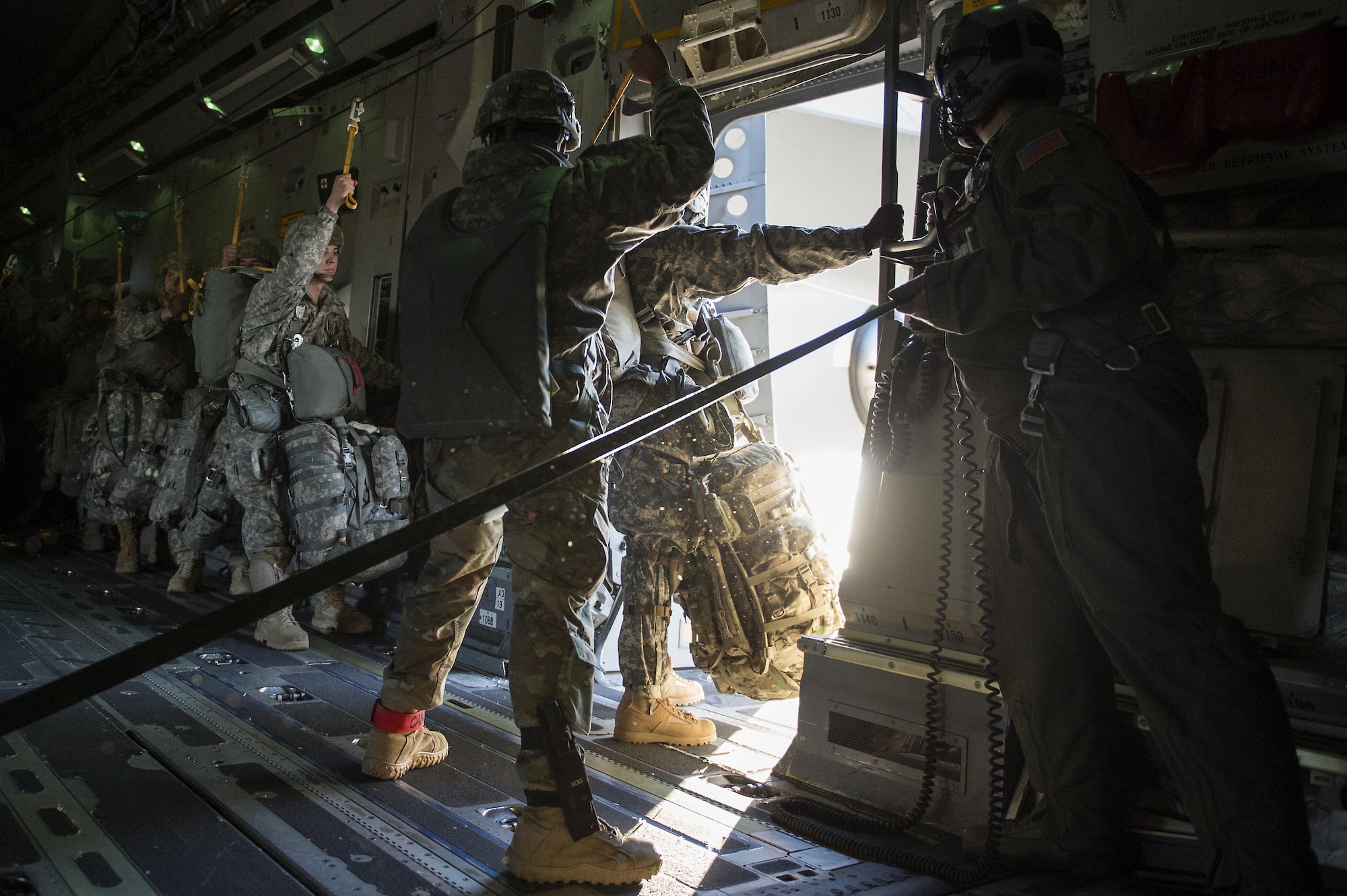 U.S. Army Alaska Soldiers assigned to the 4th Infantry Brigade Combat Team (Airborne), 25th Infantry Division, prepare to jump out of a C-17 Globemaster III during a formation flight from Joint Base Elmendorf-Richardson, Oct. 19, 2016. 